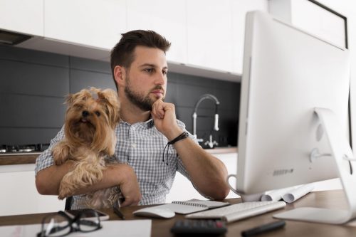 handsome-adult-male-holding-pet-while-working-scaled-e1606741916701